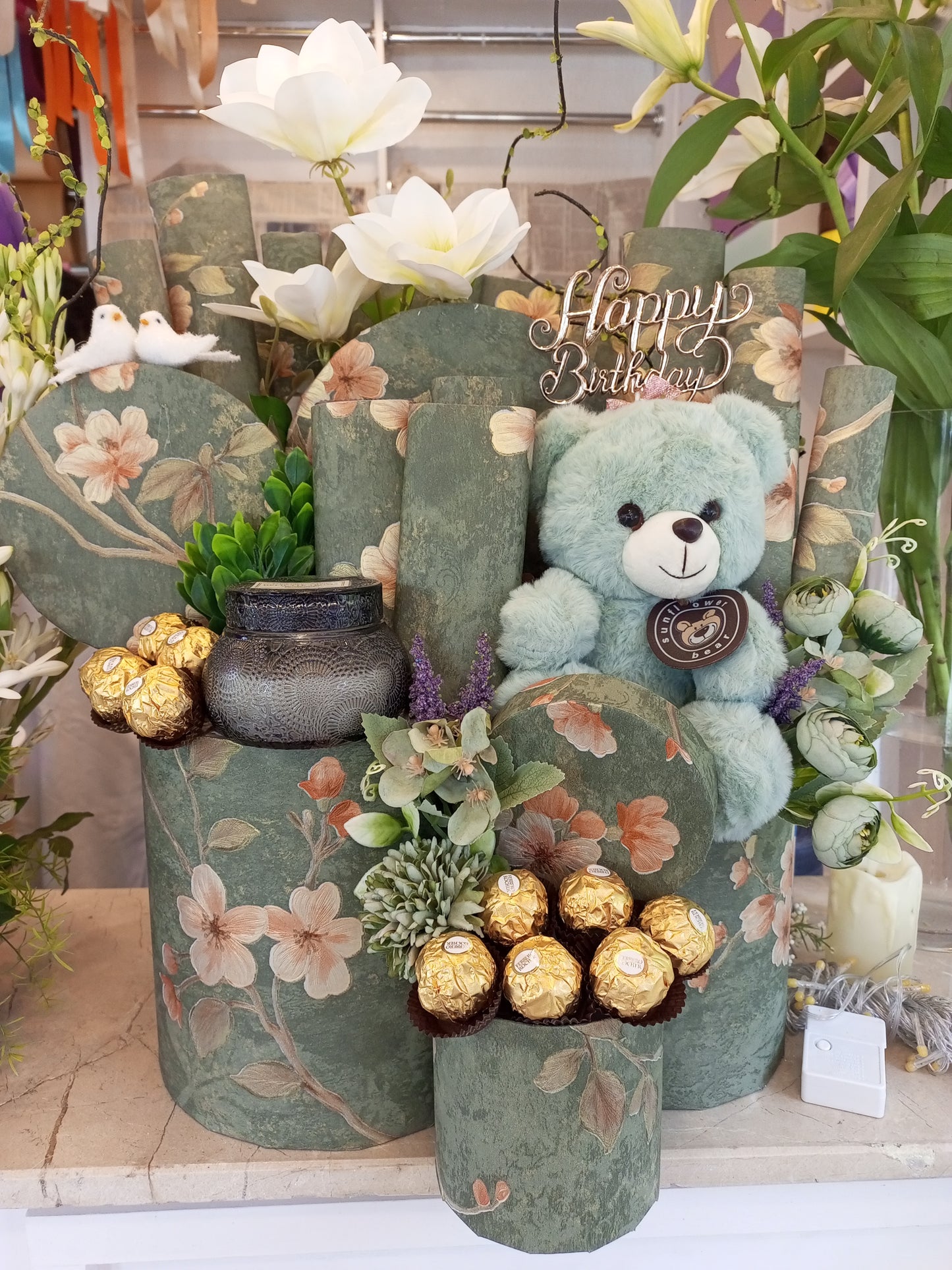 Green Chocolate Gift Basket with Teddy Bear, Fragrance Candle, Sparrows & Artificial Lily